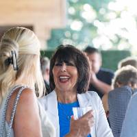 President Mantella talking and laughing with two other reception guests